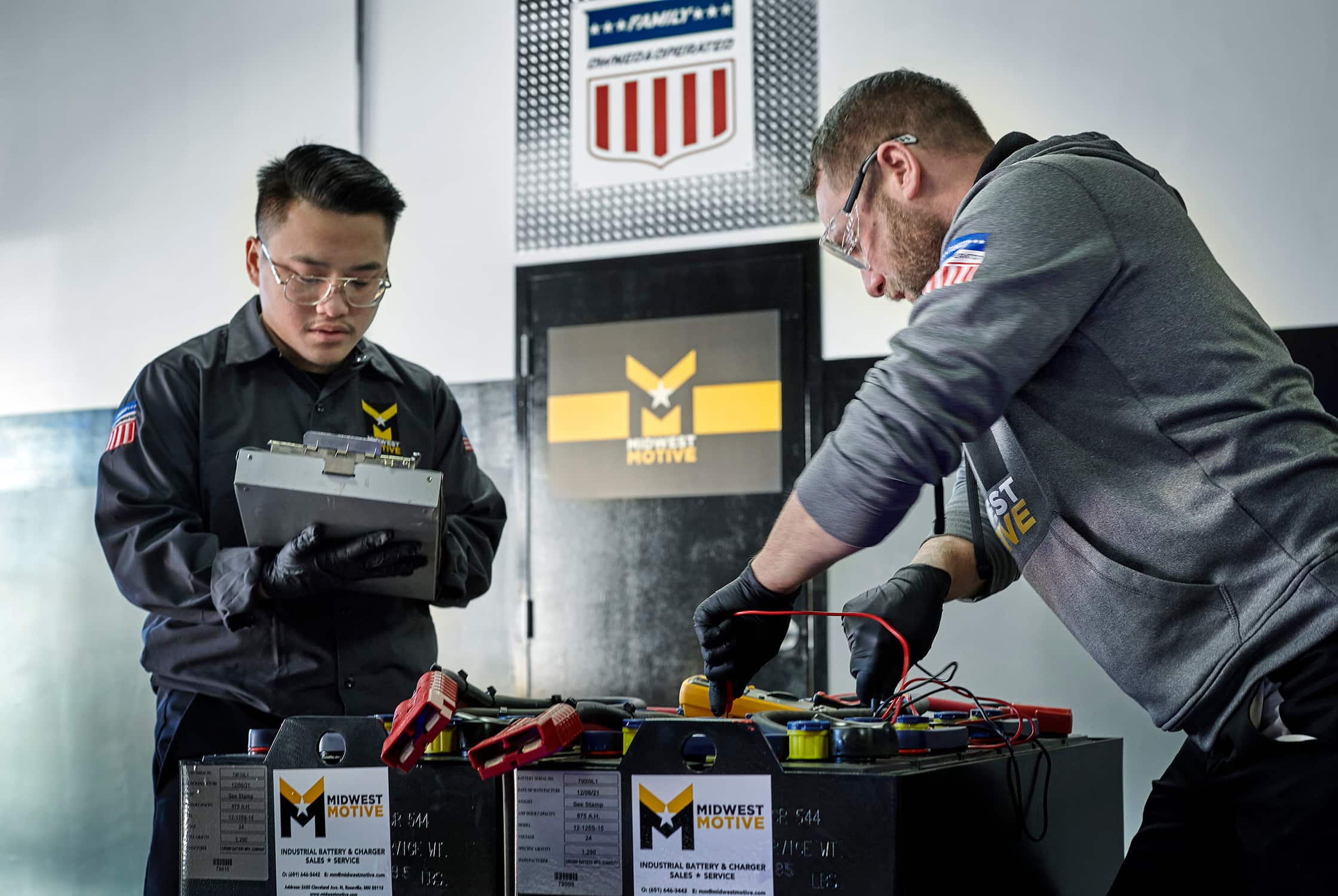 Battery technicians testing batteries.