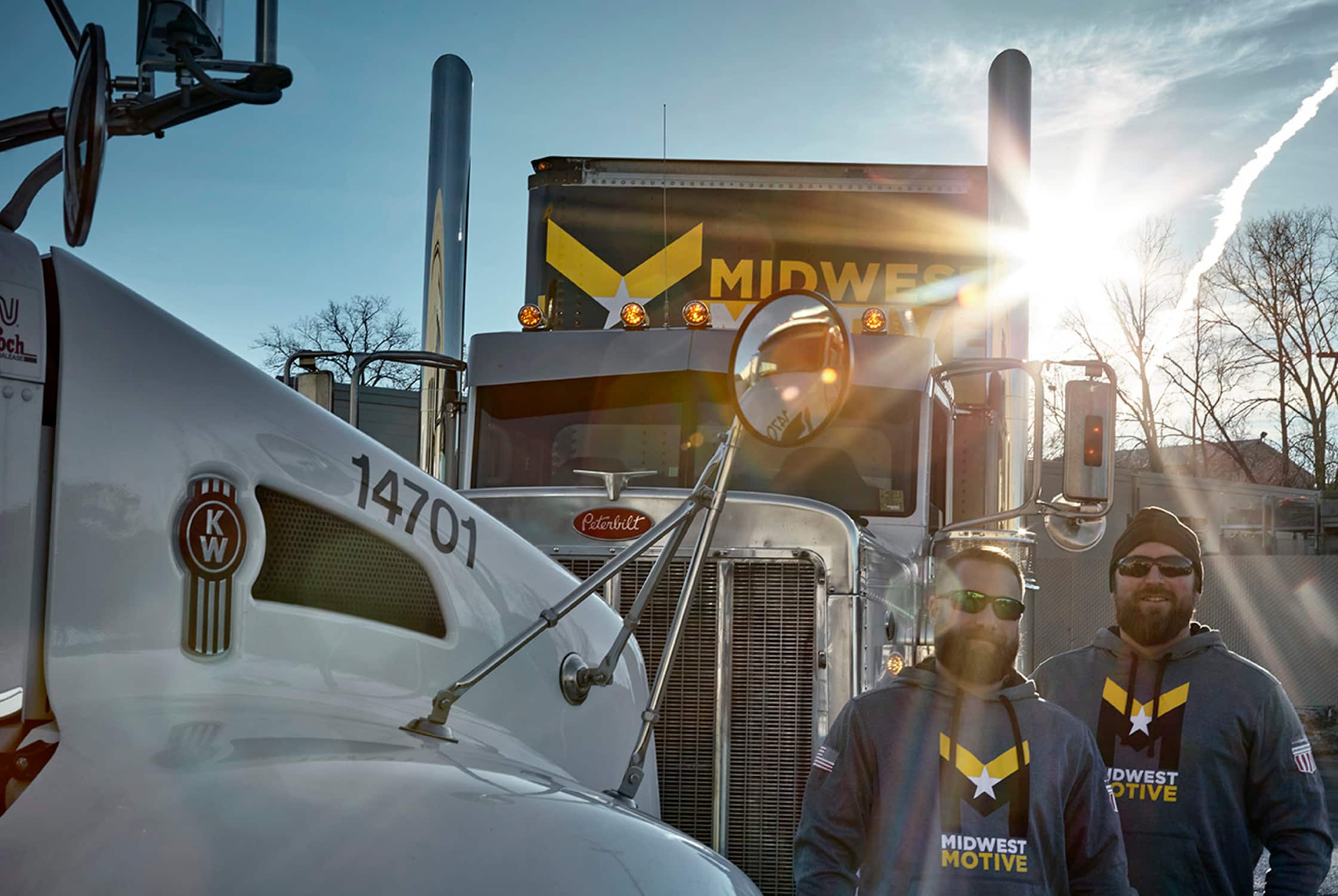 Midwest Motive drivers amongst semi-trucks.