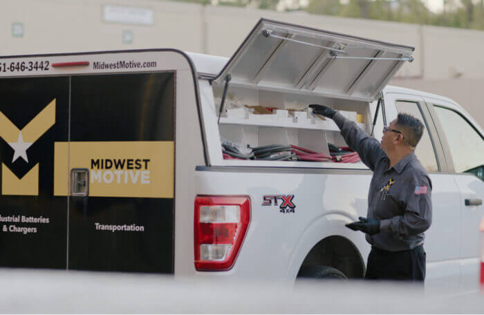 A worker getting gear from a truck